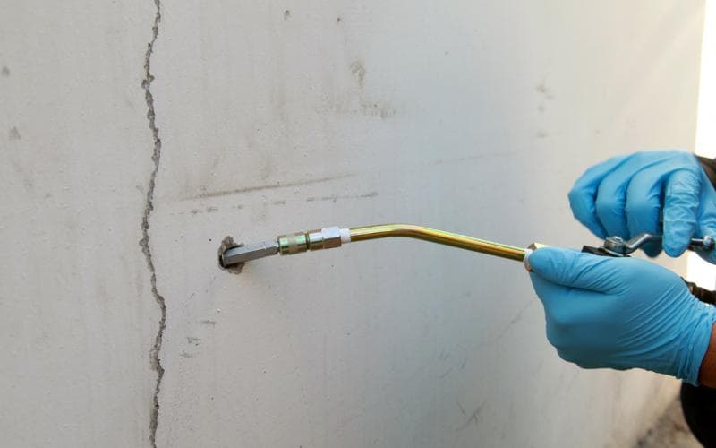 Injection repair being applied to a concrete crack