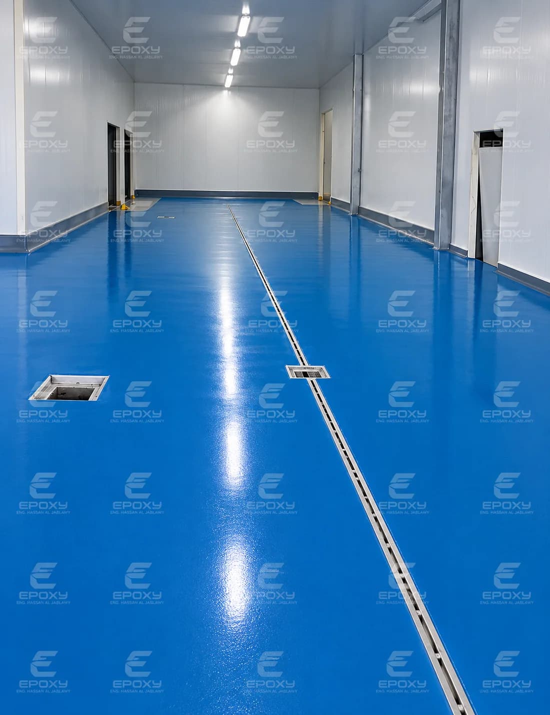 Blue epoxy floor with crisp white linework inside an Enterplin facility