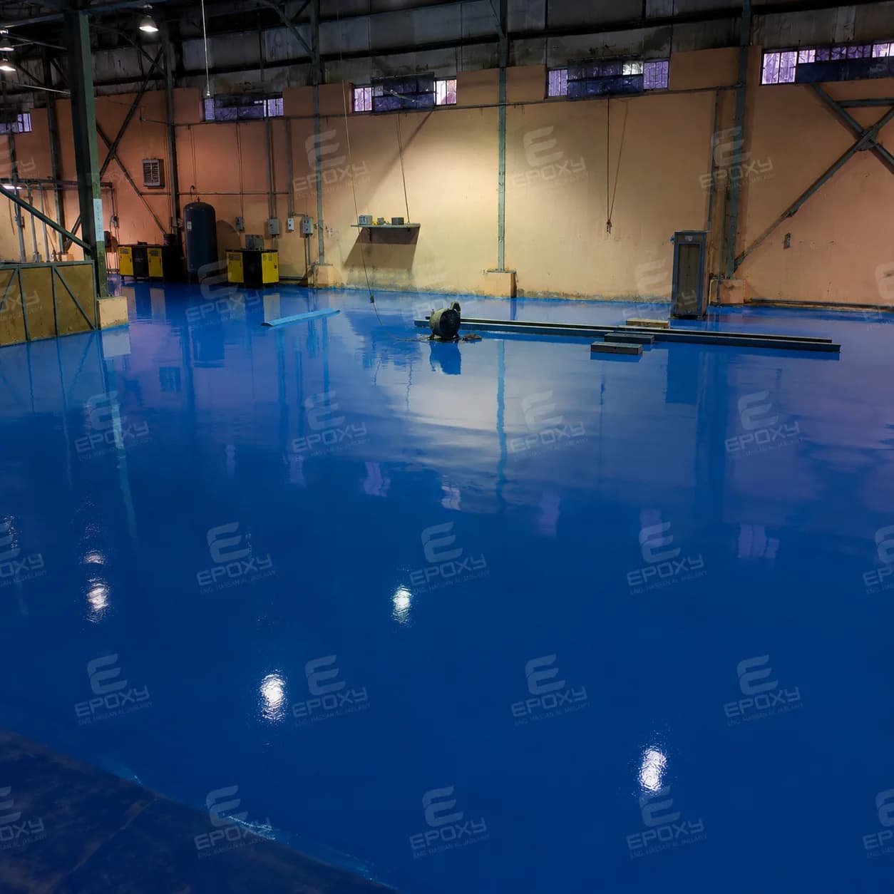 Glossy blue industrial floor inside the Hummer SYM factory