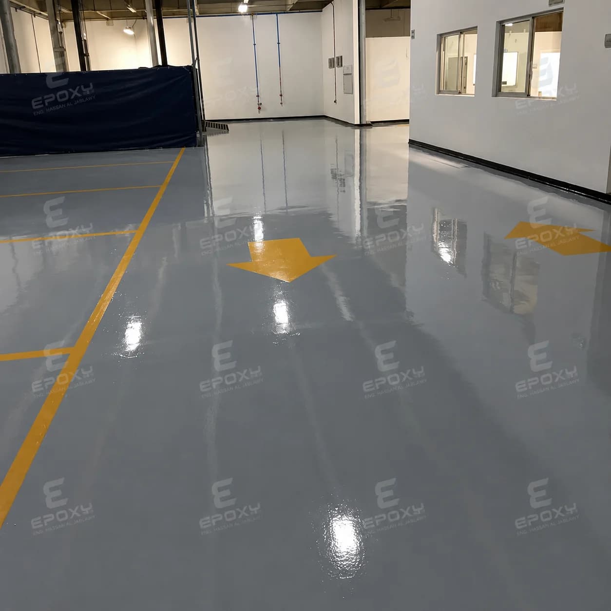 Grey epoxy floor with yellow safety lines inside a Hyundai facility